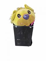 Lion head mascot costume made of plush material with a large, cartoonish lion face including big eyes, blue nose, and mane. Presented inside a black carrying bag.