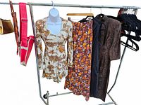 Photo of vintage clothing and bags displayed on a rack; includes 4 clothing pieces and 3 bags showing colors and patterns.