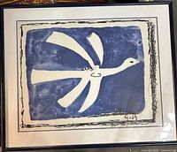 Framed lithograph showing a large white bird on blue background with signature.