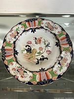 Top side view of the antique Ironstone plate showing detailed floral center and scalloped rim design.