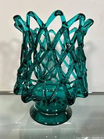 Front view of teal-colored lattice designed Italian art glass vase showing flared top rim and solid round base