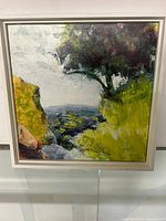 Framed landscape painting by Julie King featuring nature with rocks, trees, and hills with a dynamic color palette.
