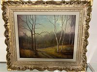 Framed oil on canvas painting showing a forest scene with bare trees and a dirt path, signed by Paradys in the lower right.
