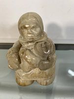 Front view of the Inuit stone carving showing woman holding child