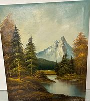 Oil painting showing a landscape with pine trees, a river, and distant snow-capped mountains.