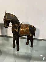 Full view of the wooden horse with brass decorations