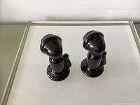 Front view of both telephone-shaped shakers