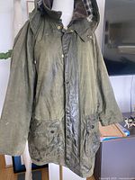Front view of Barbour wax jacket showing hood, pockets, overall wear