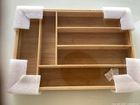 Top view of bamboo drawer organizer tray with protective foam on corners