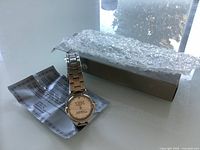 Overall view of watch, box, bubble wrap, warranty card