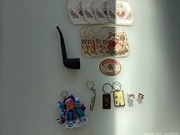 All items laid out: pipe, cigar labels, keychains, pins