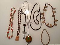 All seven jewellery pieces laid out on flat surface