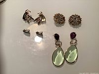 All earrings laid out showing front designs