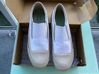 Top view of both Medium slip-on shoes in box