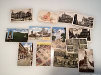 Top, middle and bottom rows showing all 14 postcards laid out on surface