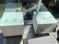 Both rolling cube tables side by side showing tops and casters