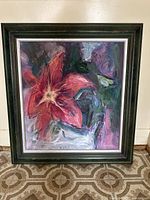 Front view of the full painting in its decorative frame against a wall.