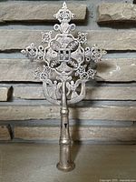 Full front view of finial against stone backdrop