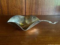 Angled view showing bowl and spoon set on wooden surface