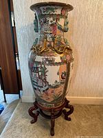 Full view of vase on stand against wall