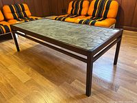Full side view of the rectangular rosewood coffee table with ceramic tile top, showing wood color and tile pattern.