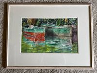 Framed artwork hung on carpeted surface