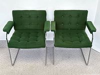 Front view of both armchairs side by side showing upholstery and frame