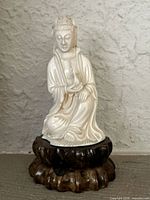 Front view of entire figurine on wooden base