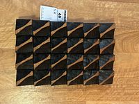 Top-down front view showing the rectangular wooden panel with geometric hand carved raised triangular shapes, stained dark and natural wood finish alternating pattern.