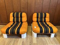 Front view of both chairs showing overall form and upholstery pattern