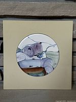 Full front view of square board with round ceramic tile mounted centrally