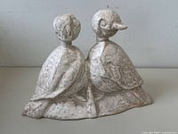 Front view of speckled white ceramic dual-bird sculpture