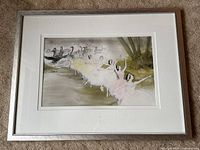 Full front view of framed watercolor depicting ballet dancers and black swans in a natural setting.