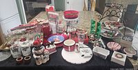 Wide view showing assorted Christmas kitchen items including glassware, platters, and various kitchen accessories arranged on a table.