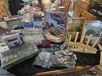 Overview of diverse Christmas light products arranged on table including rope lights, bubble lights, mini lights, decorative tree lights, and candle lights.