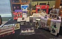 Wide view of holiday village set including houses, figures, trees, and accessories on black cloth