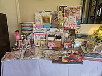 Wide view of the craft lot showing puzzles, Diamond Dot art, craft paints, Spirograph set, coloring books, markers, needle point, stencils, and boxes.