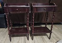 Pair of cherry finish end tables showing front and legs with drawer and shelf