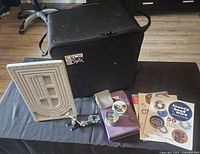 Closed carrying case with small tool setup and instructional books around it