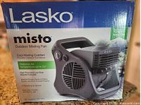 Box of Lasko Misto Outdoor Misting Fan showing front with product image, brand, and main features.