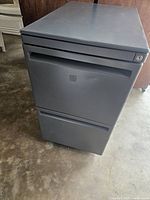 Front view of gray metal 2-drawer file cabinet showing drawer fronts and lock.