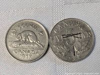 Pair of Canadian nickel coins, 1937 and 1920s, showing front sides with beaver and text.