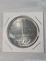 Close-up photo of the front side of the 1951 Sudbury Big Nickel coin showing detailed engravings and protective holder