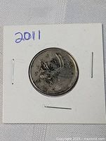 Image showing 2011 Canadian quarter with visible doubling in '25 CENTS' area and caribou design.