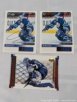 Three Curtis Joseph hockey cards in protective sleeves on a flat surface, showing full card fronts