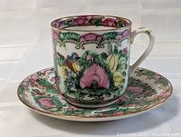 Porcelain cup and saucer set viewed from front angle showing decoration and handle
