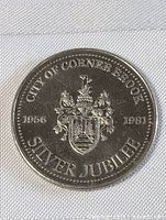 Front side of the City of Corner Brook Silver Jubilee coin showing crest and inscriptions.