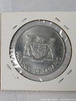 Front view of silver-colored commemorative coin displaying the Province of Ontario coat of arms enclosed in a protective 2x2 holder.