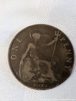 Image of front side of 1917 British one penny coin showing Britannia seated with trident and shield