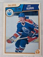 Front of Jarri Kurri hockey card showing player in Edmonton Oilers uniform, blue and orange colors dominant.